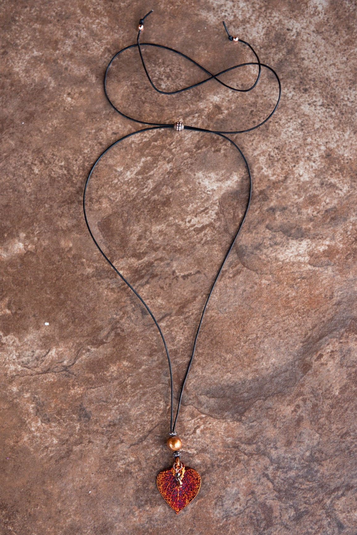 One Bronze pearl, Copper leaf,black leather cord and bronze pearl dangle