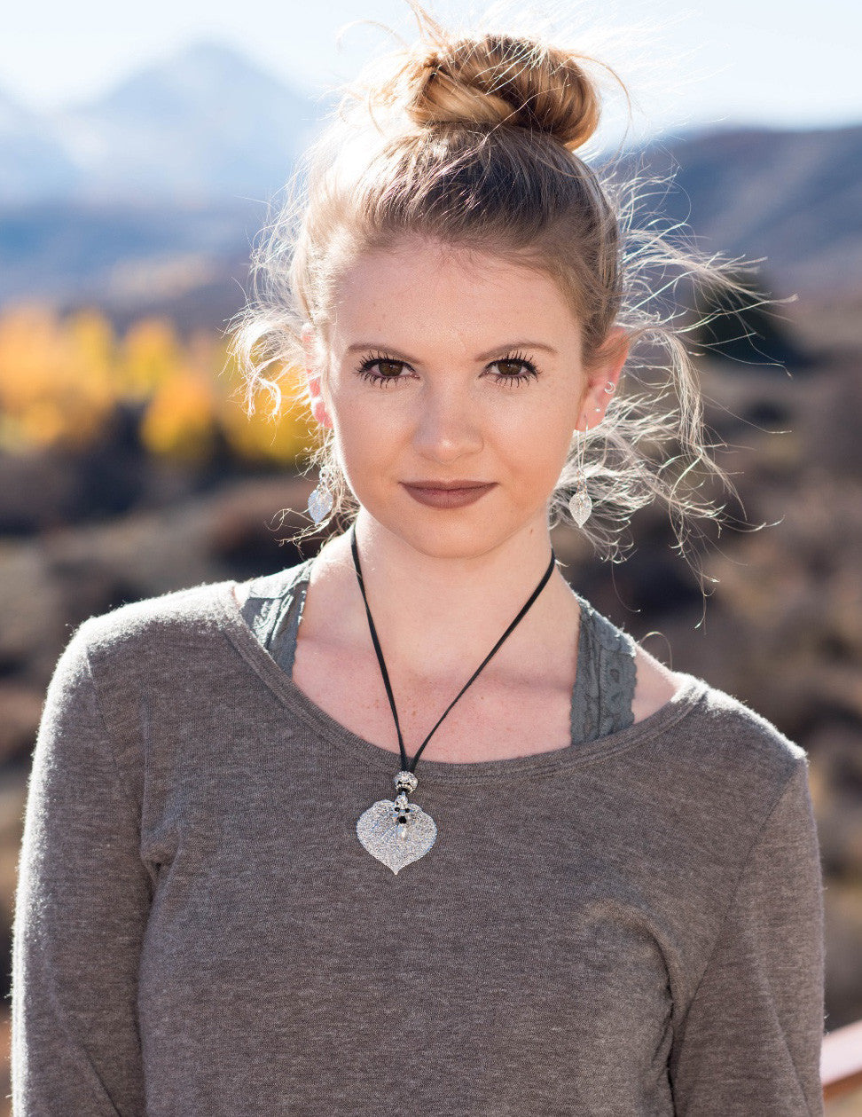 Single Aspen leaf, black deerskin leather, embellished with a crystal-studded bead and crystal dangles