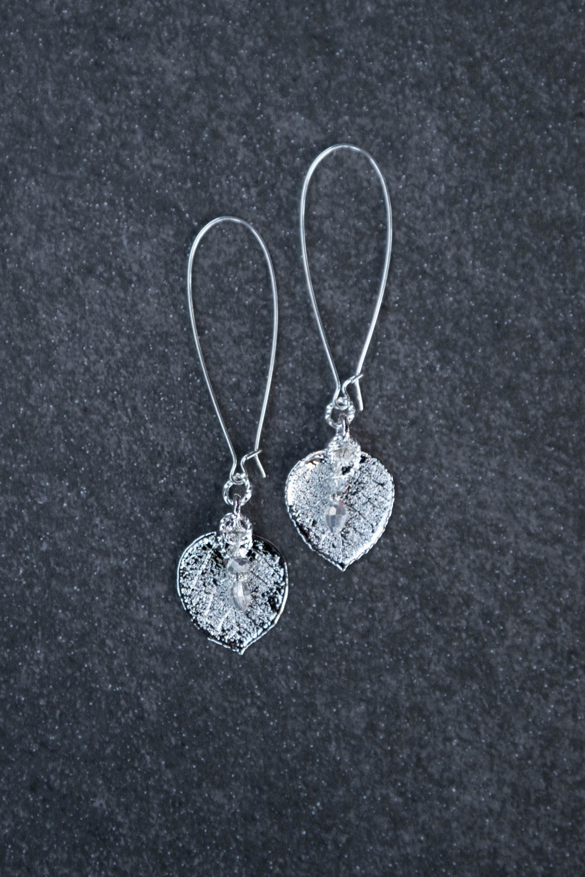 Silver earrings: Silver leaves come together with teardrop light weight long silver hoops. Finished with crystal dangles