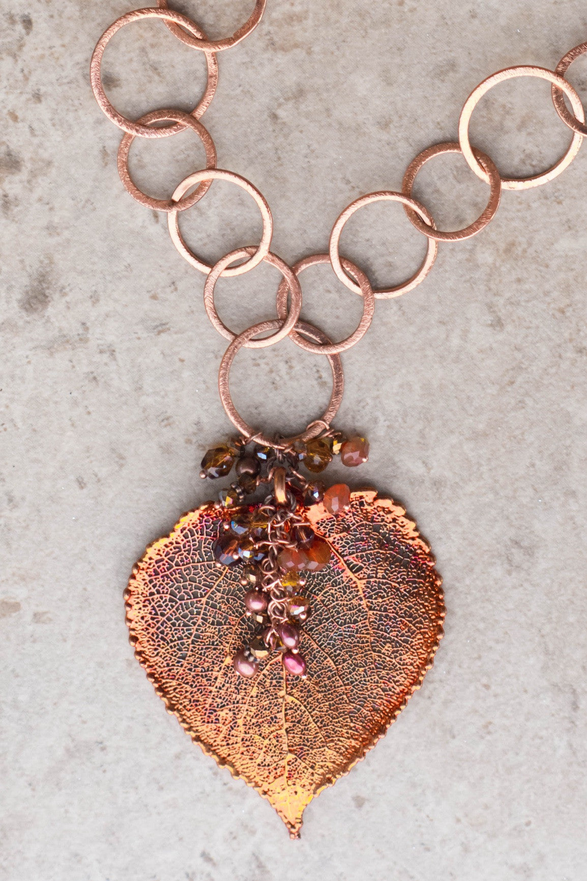 Signature Copper chain combined with a large Copper leaf and crystal dangles creates this striking necklace