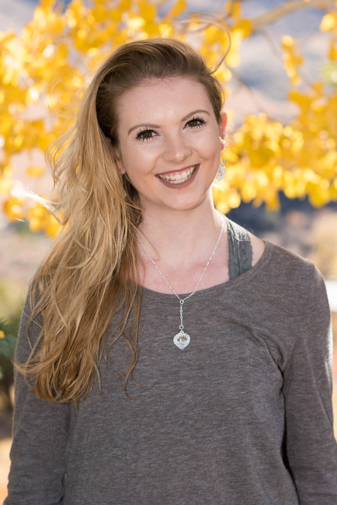 Classic silver chain creates this dramatic Y style necklace with a small Silver leaf