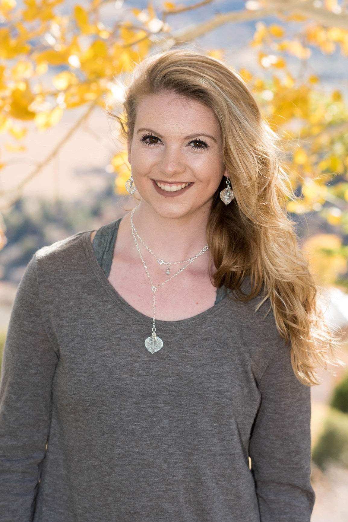 Classic silver chain creates this dramatic Y style long necklace with a small Silver leaf