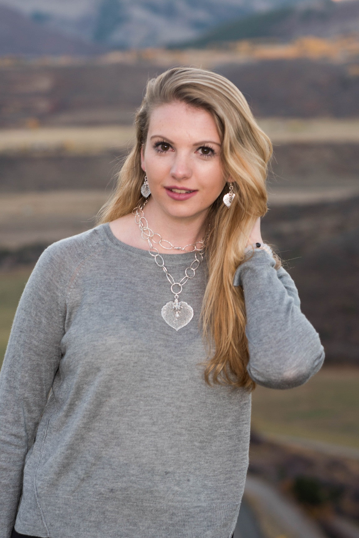 Classic silver faceted chain creates a modern long necklace with a Silver leaf and crystal dangles