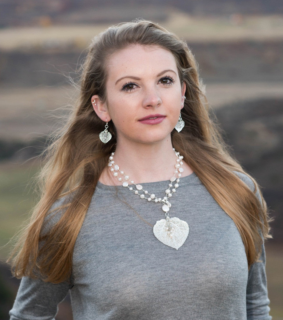 Wire twisted silver combine long strands of white freshwater & coin pearls finished with a Silver Aspen leaf & pearl dangle.