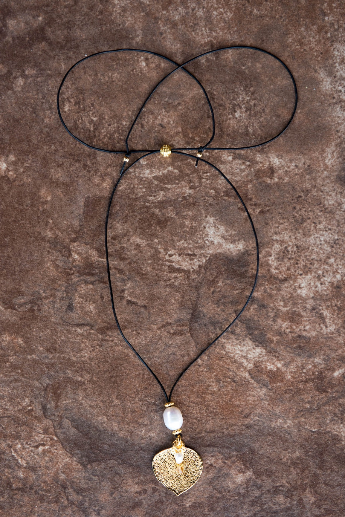 One White pearl,Gold leaf, black cord and white pearl dangle