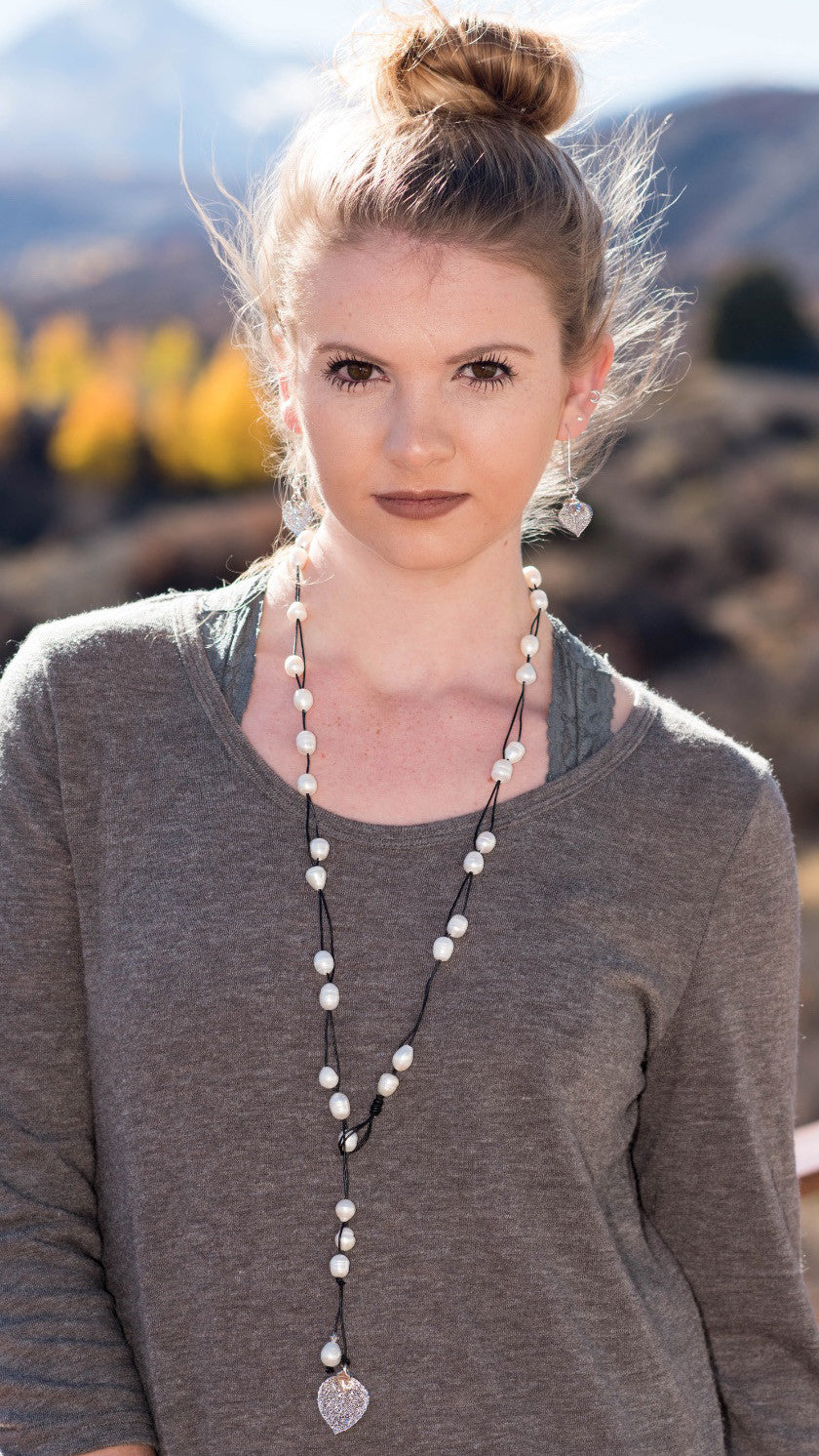 Lariat: Multi pearls accent this impressive necklace, White freshwater pearls, silver Aspen leaf, black cord leather.