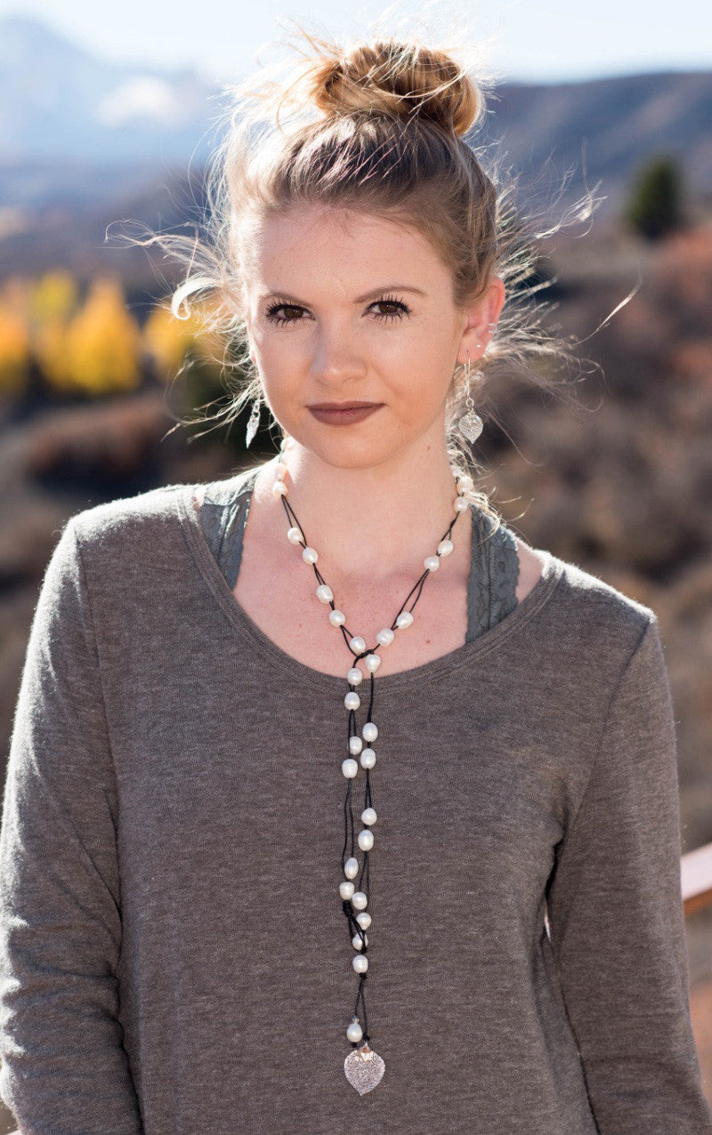 Lariat: Multi pearls accent this impressive necklace, White freshwater pearls, silver Aspen leaf, black cord leather.