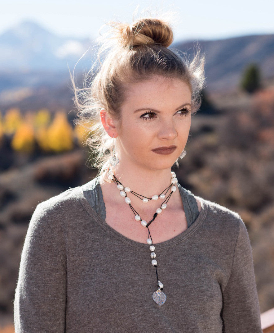 Lariat: Multi pearls accent this impressive necklace, White freshwater pearls, Gold Aspen leaf, black cord leather.